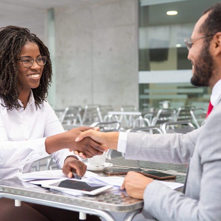 cheerful-businesspeople-reaching-agreement